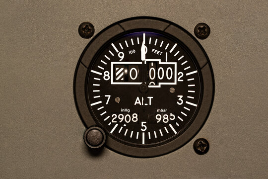 Aircraft altimeter set to zero feet above sea level. Analog airplane instrument for displaying altitude to a pilot. Steam gauge type instrument cluster, six pack. 