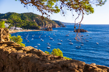 Small boats anchored in the bay of Tossa de Mar, seen from the old town’s walls