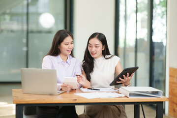 Asian business woman working and talking about graph documents