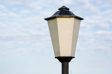 Glowing street lamp against the background of autumn red oak leaves. Street lamp against the autumn...