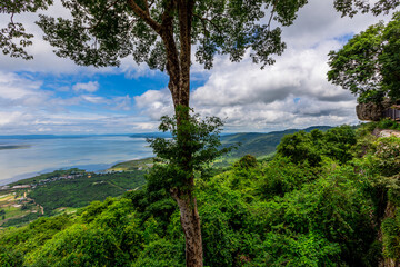 Obraz premium Panoramic nature background from a viewpoint on a high mountain overlooking the scenery below, river, road, rocks, trees, the beauty of nature during a trip in Khon Kaen, Thailand.