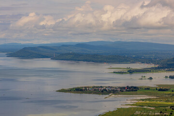 Panoramic nature background from a viewpoint on a high mountain overlooking the scenery below, river, road, rocks, trees, the beauty of nature during a trip in Khon Kaen, Thailand.