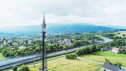 5G Telecommunications tower above rural town and highway