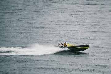Fototapeta premium Coast Guard patrol boat speeding through rough sea waves