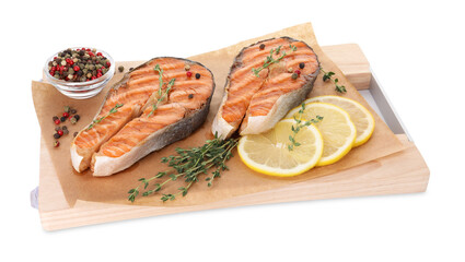 Tasty grilled salmon steaks with peppercorns, lemon and thyme isolated on white