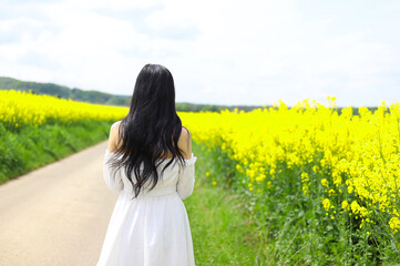 An Asian sad girl wears white cloth on the rep flowers.