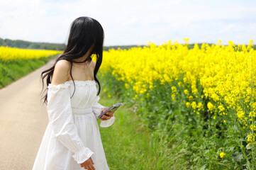 An Asian beautiful girl wear white cloth on the reps flower garden