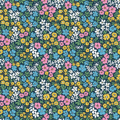 Beautiful floral pattern in small flowers. Small multicolor flowers. Dark blue background. Ditsy print. Floral seamless background. Cute template for fashion prints. Stock pattern.