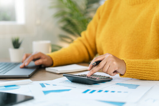 Business Accountant Calculating Taxes, Income-Expenses and Analyzing Investment Data Reports. Annual Tax Deduction Planning Concept, Financial and Tax System.