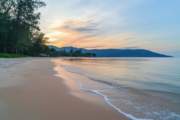 Obraz premium Serene beach sunset with calm waters, soft sand, and lush greenery
