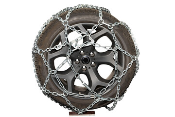 A rugged tire wrapped in chains resting on a stand in a workshop for winter preparation, isolated on white background.