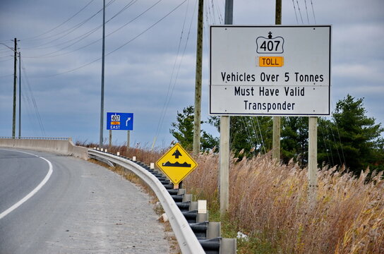 Ontario, Canada, November 8, 2024: Traffic and road signs on Highway 407 near Markham, Ontario. The 407 ETR is an express toll route highway owned by the 407 International Inc.