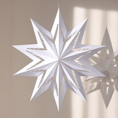 Obraz premium Hanging white folded paper Christmas star ornament casting dramatic sharp shadows on a neutral background, perfect for winter holiday decor.