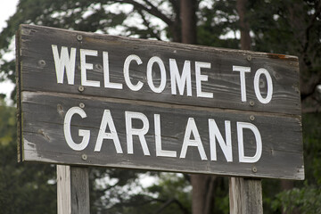 Elegant wooden "Welcome to Garland" sign, perfect for US city entrance road signs, travel signage, urban landmarks, and city-themed promotional projects.