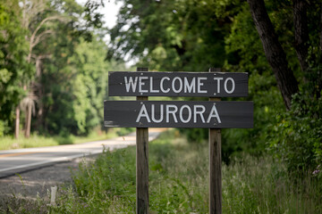 Stylish wooden "Welcome to Aurora" sign, ideal for US city entrance road signs, travel signage, urban landmarks, and city-themed branding projects.