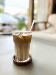 Ice coffee with a blurred cafe background. copy space.
