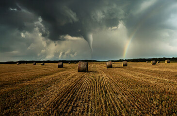 Stormy panorama featuring a tornado over agricultural plains, illustrating climate change