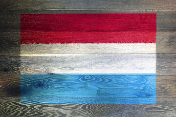 Luxembourg flag on rustic old wood