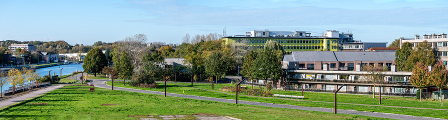 Obraz premium High angle view over apartments and grassland park in Vilvoorde, Flemish Brabant, Belgium, OCT 26, 2024