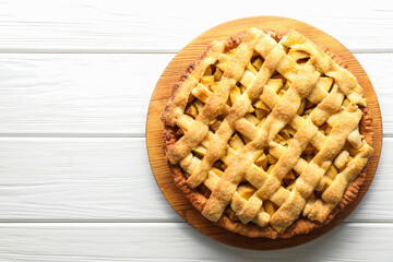 Tasty homemade apple pie on white wooden table, top view. Space for text