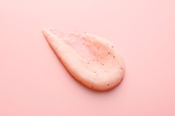 Smear of body scrub on light pink background, closeup