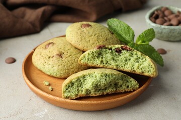 Delicious mint chocolate chip cookies on light table, closeup