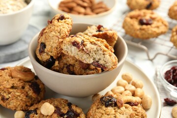 Delicious oatmeal cookies with raisins and nuts on table, closeup