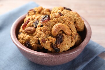 Delicious oatmeal cookies with raisins and nuts on table, closeup