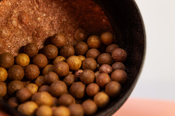 Make-up for the face, solid bronzer and bronzer for the face with shimmer and golden undertone in balls, loose powder, beauty products close-up.