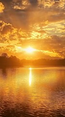 Fototapeta premium Serene Sunset Casting Golden Light Over Still Water