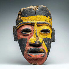 Weathered Ancient Carved Mask Displaying Bold Colors and Unique Features, Showcasing the Rich Cultural Heritage and Artistic Expression of Its Time, Perfect for Art and History Enthusiasts