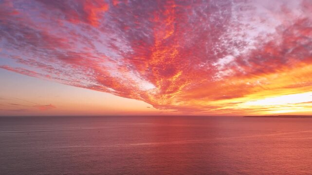 Epic sunset over the Atlantic Ocean with firing clouds in the sky. view from Portimao, Portugal