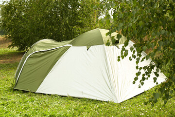 One camping tent on green grass outdoors