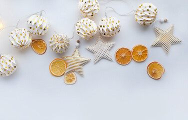 decorative Christmas stars, garland and dried orange citrus slices on white background.New year and Christmas holidays concept. festive winter season. top view. copy space