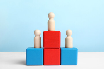 Winner. Wooden figures on podium against color background