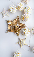Christmas star, decorations and garland on white background. symbol of Christmas and New Year holidays. festive composition for winter season. top view