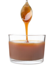 Tasty caramel sauce dripping from spoon into glass bowl on white background, closeup