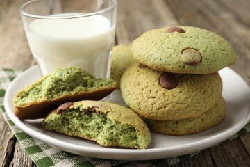 Delicious mint chocolate chip cookies and milk on wooden table, closeup