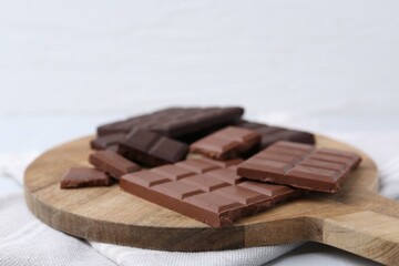 Different types of chocolate on light table, closeup