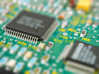 Close-up of microcircuits and components: chips, diodes and capacitors on a printed circuit board,...