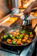 Stir frying fresh vegetables and shrimp in black wok pan on professional restaurant kitchen stove, cooking Asian cuisine with steam rising in warm lighting.