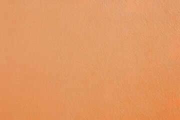 A plain, solid-colored background with a uniform shade of light orange