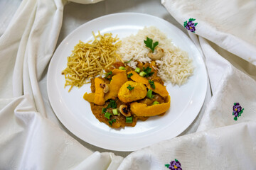 Traditional and exotic Brazilian dish rice, chicken and pequi (caryocar brasileinse) 