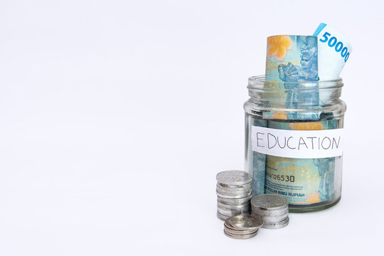 some bills rupiah in a clear jar for education