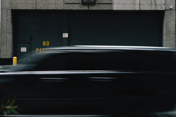 Dynamic Urban Scene Featuring a Blurred Vehicle in Hustling City Environment