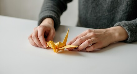 Obraz premium Tranquil origami craft session with delicate paper crane