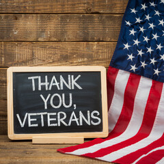 text thank you veterans in a chalkboard and the flag of the US
