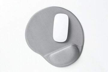Mouse and mousepad with arm rest on white table, top view
