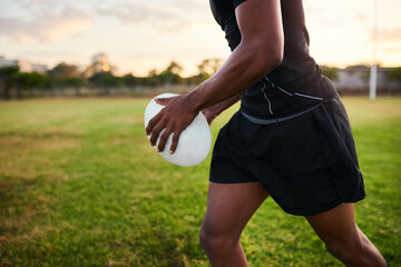 Hands, performance and player with ball, rugby and training for match, energy and athlete with fitness. Outdoor, action and person in stadium, professional and preparing for competition and field