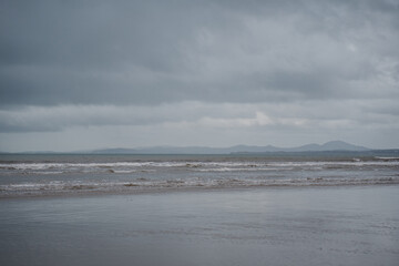Cloudy day panorama at the beach low tide